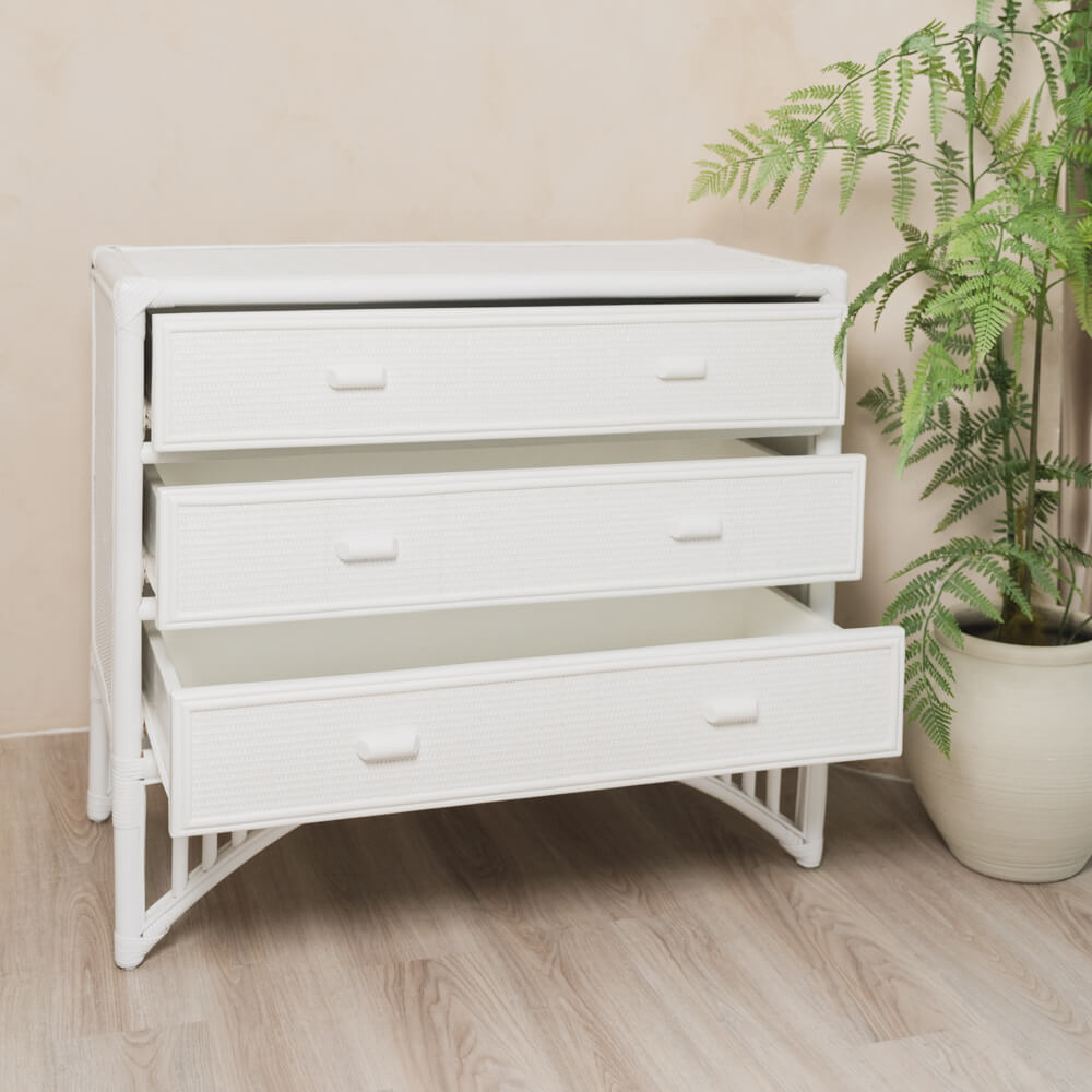 Angled view of the handcrafted rattan Coastal Haven Drawers by MOMIJI with all drawers opened, styled in a room with indoor plants.