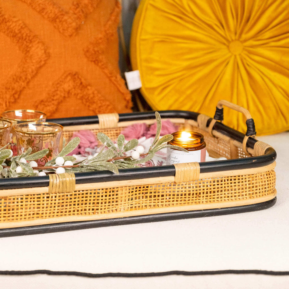 Close-up of the handle and side detail of the Coco Serving Tray by MOMIJI with accessories inside.