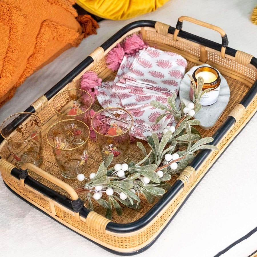 Top view of the Coco Serving Tray by MOMIJI styled with glasses, candles, and decorative flowers.