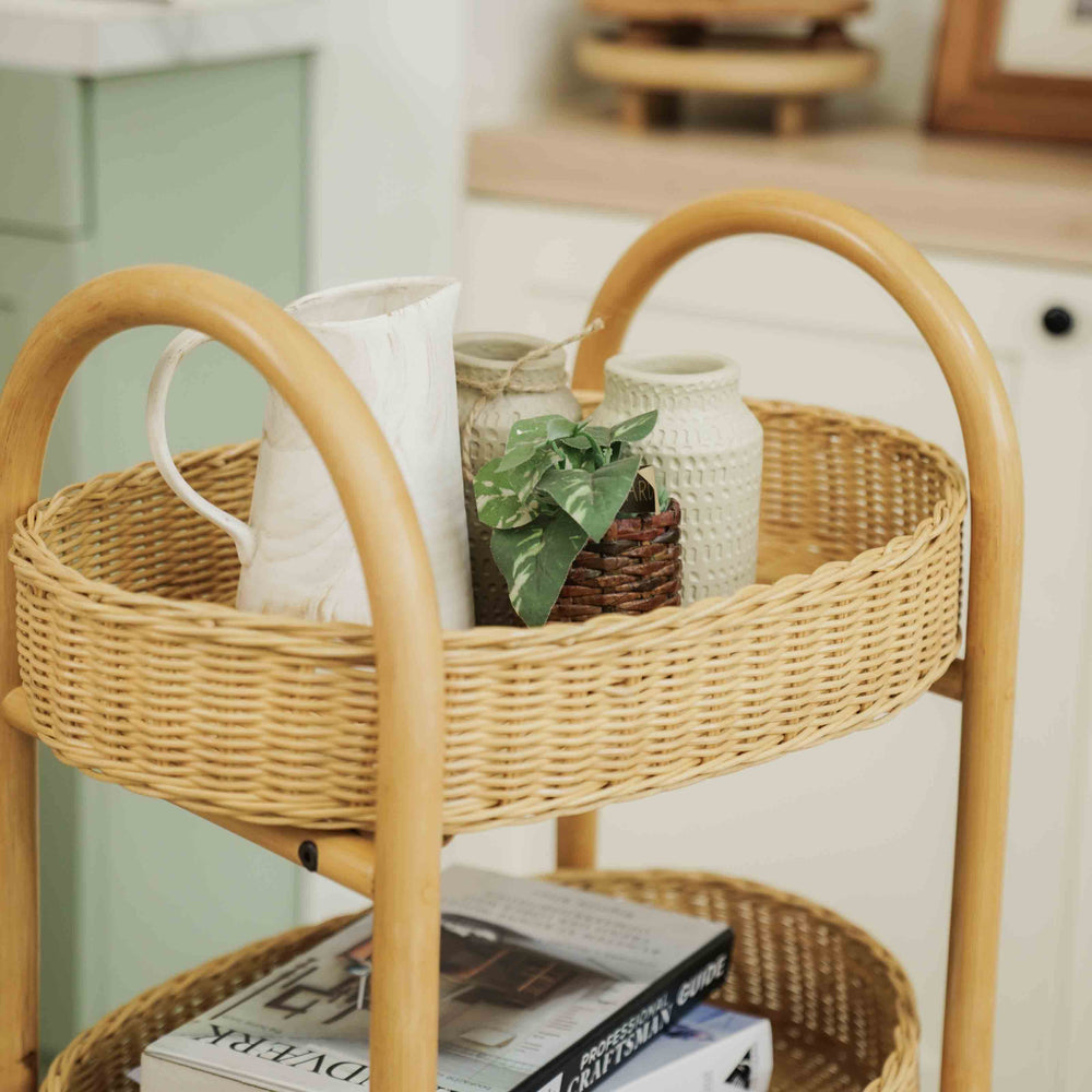 Handcrafted wicker rattan Con Craft Trolley by MOMIJI with integrated basket trays used to store books and decorative items in a home setting