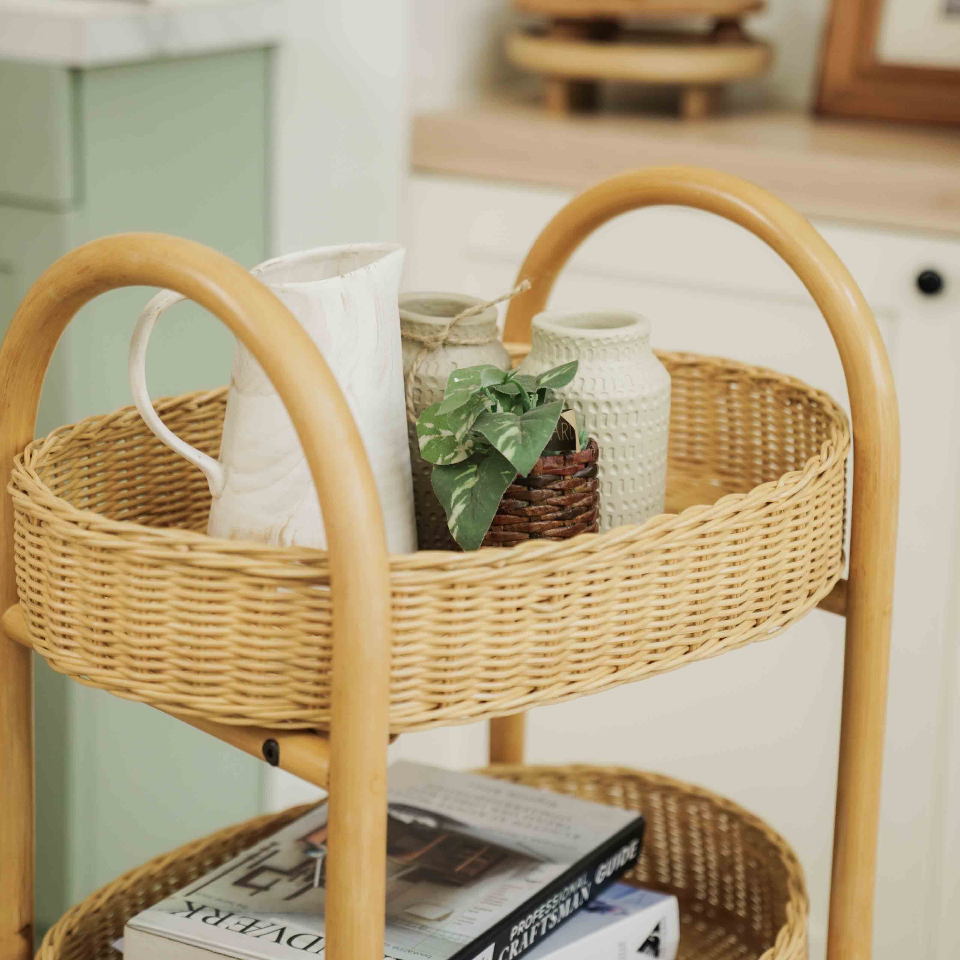 Handcrafted wicker rattan Con Craft Trolley by MOMIJI with integrated basket trays used to store books and decorative items in a home setting