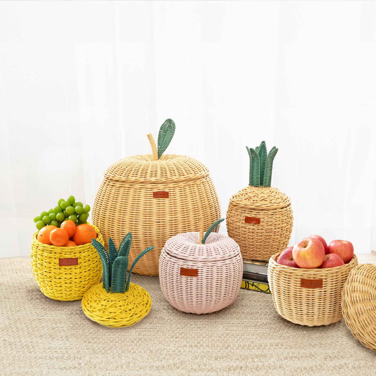 Set of wicker fruit-shaped rattan baskets on a light background