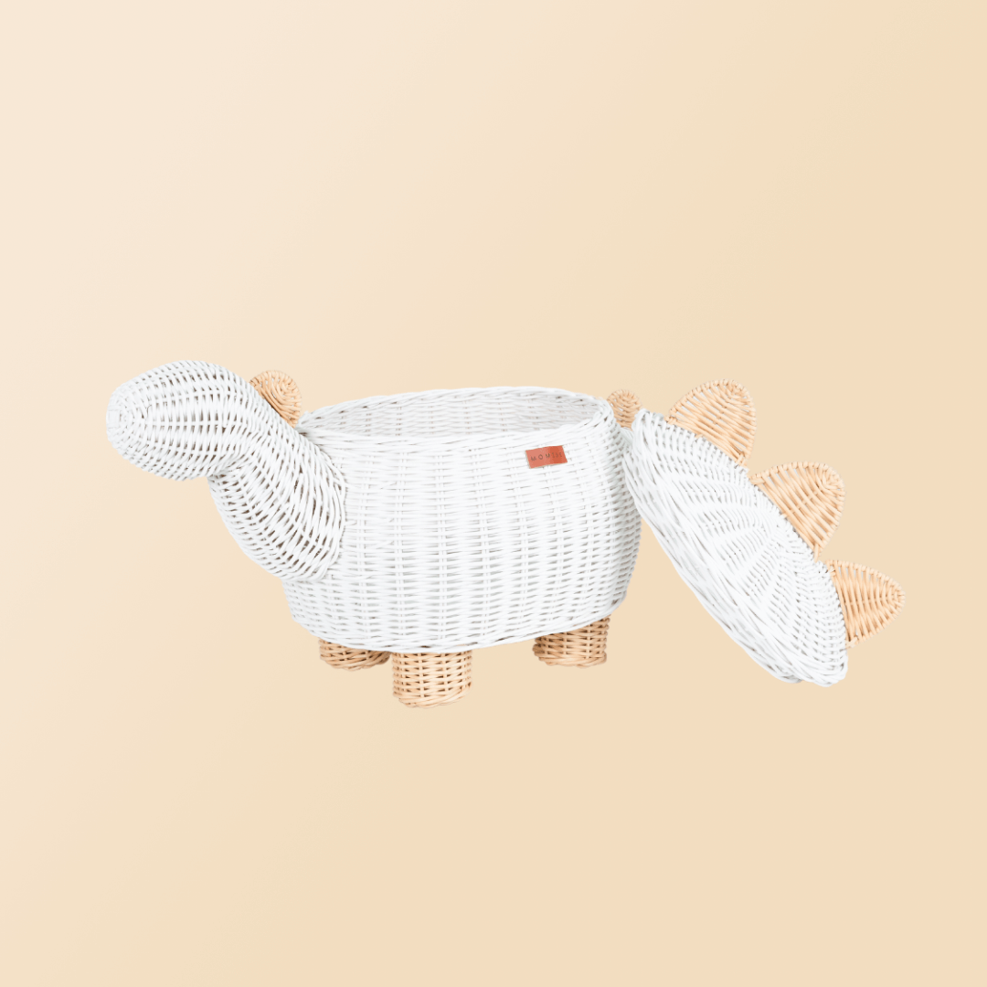 Opened white dinosaur rattan storage basket by MOMIJI with lid leaning beside the rattan basket.