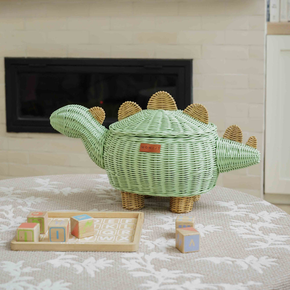 Handcrafted wicker rattan Dinosaur Storage Basket by MOMIJI in medium size used to store toys in a playful and tidy playroom