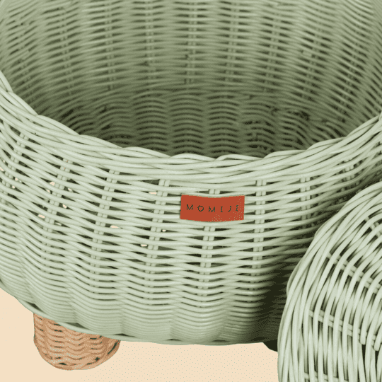 Close up view of MOMIJI logo on the Mint Green Dinosaur Storage Rattan Basket.