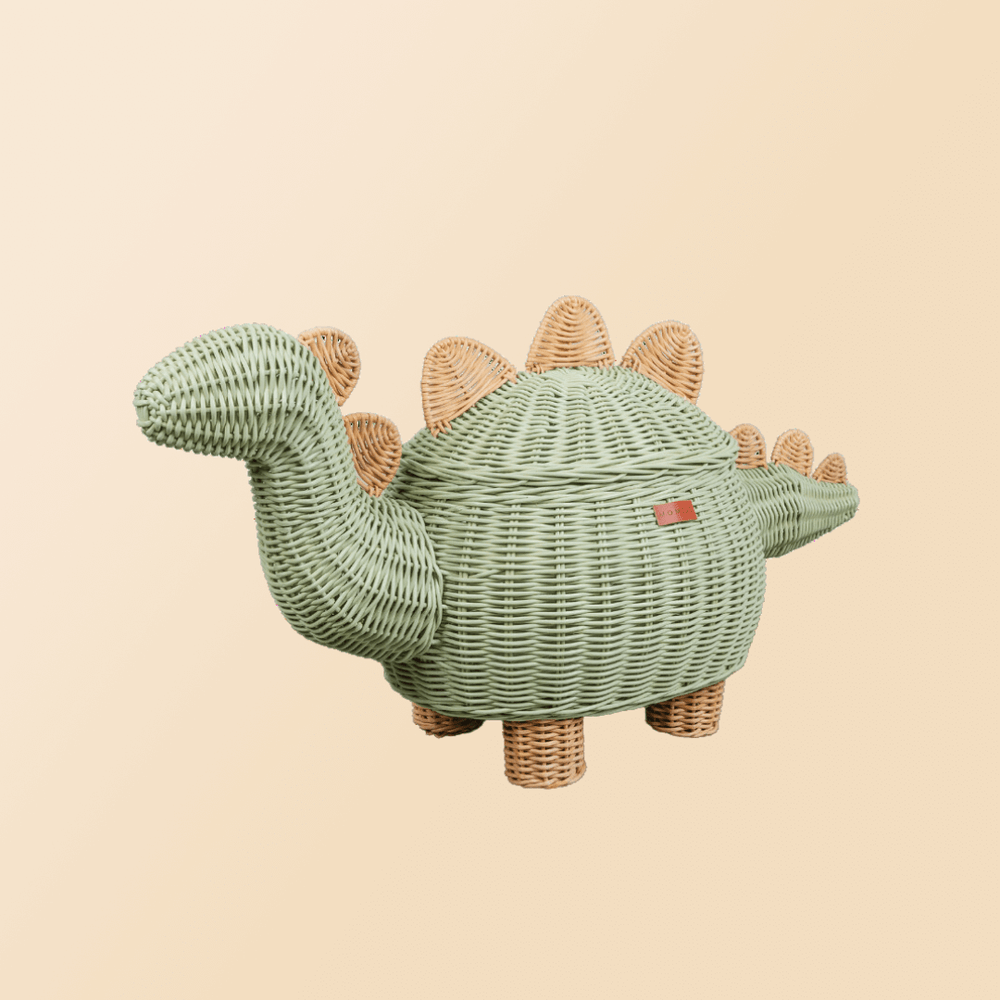 Tilted view of the Mint Green Dinosaur Storage Rattan Basket by MOMIJI in extra large size with beige background. 