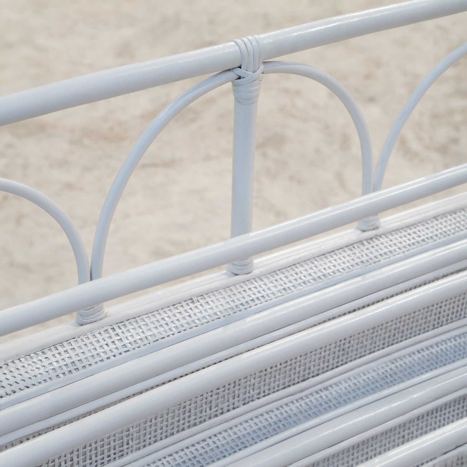 Close-up view of handwoven rattan wicker detailing on Elena Montessori Kids Bookshelf – White by MOMIJI.