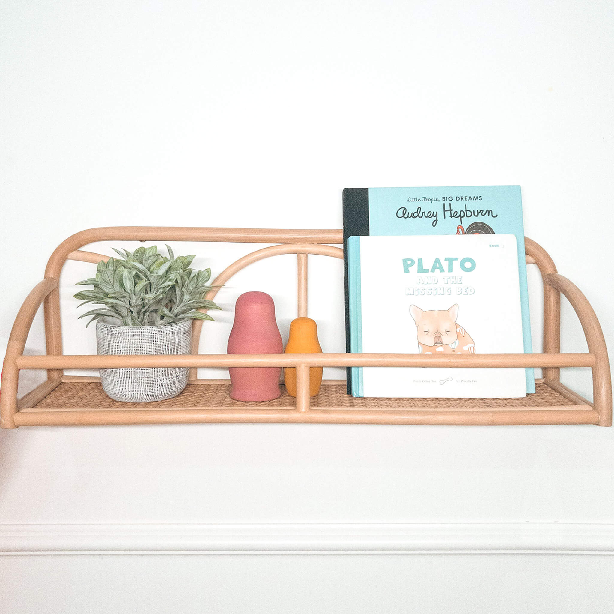 Front view of the Eloise Wall Display Shelf by MOMIJI styled with children’s books and home accessories.