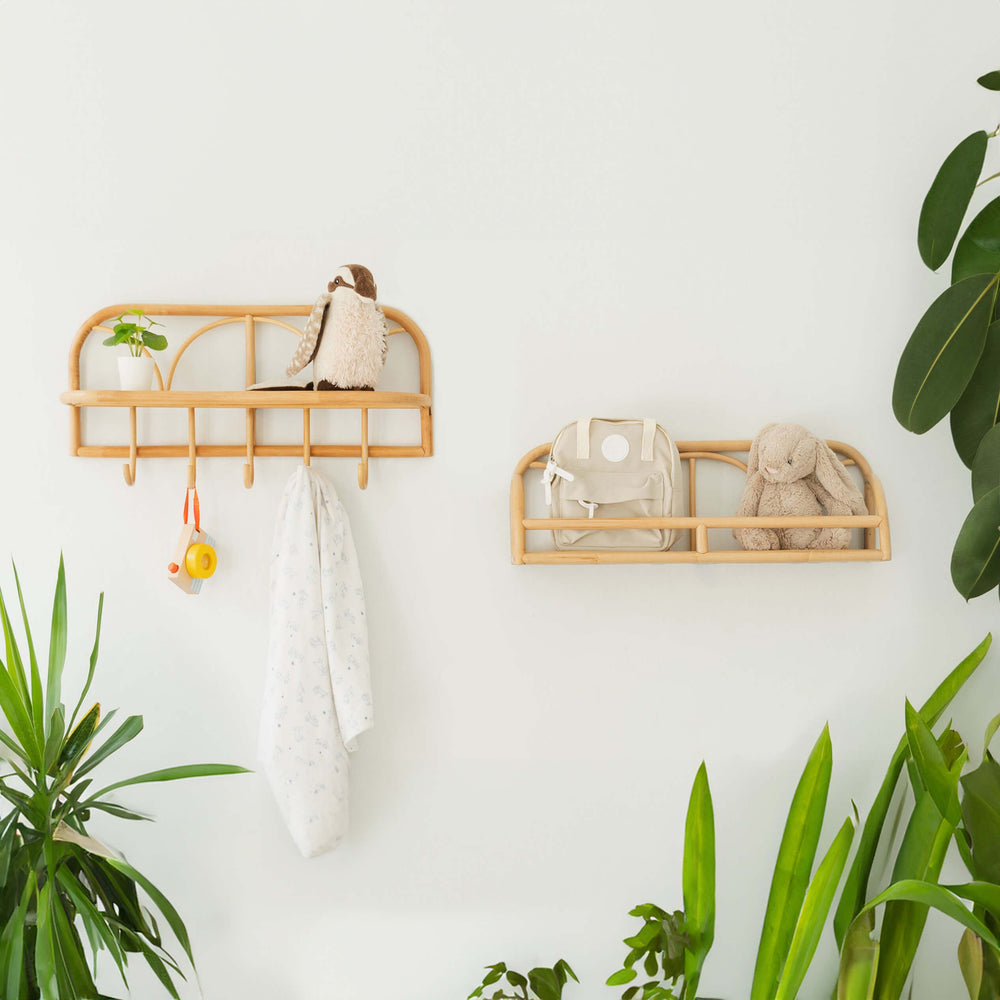 Eloise Wall Display Shelf by MOMIJI holding dolls and a children’s bag, mounted beside another hanging shelf.