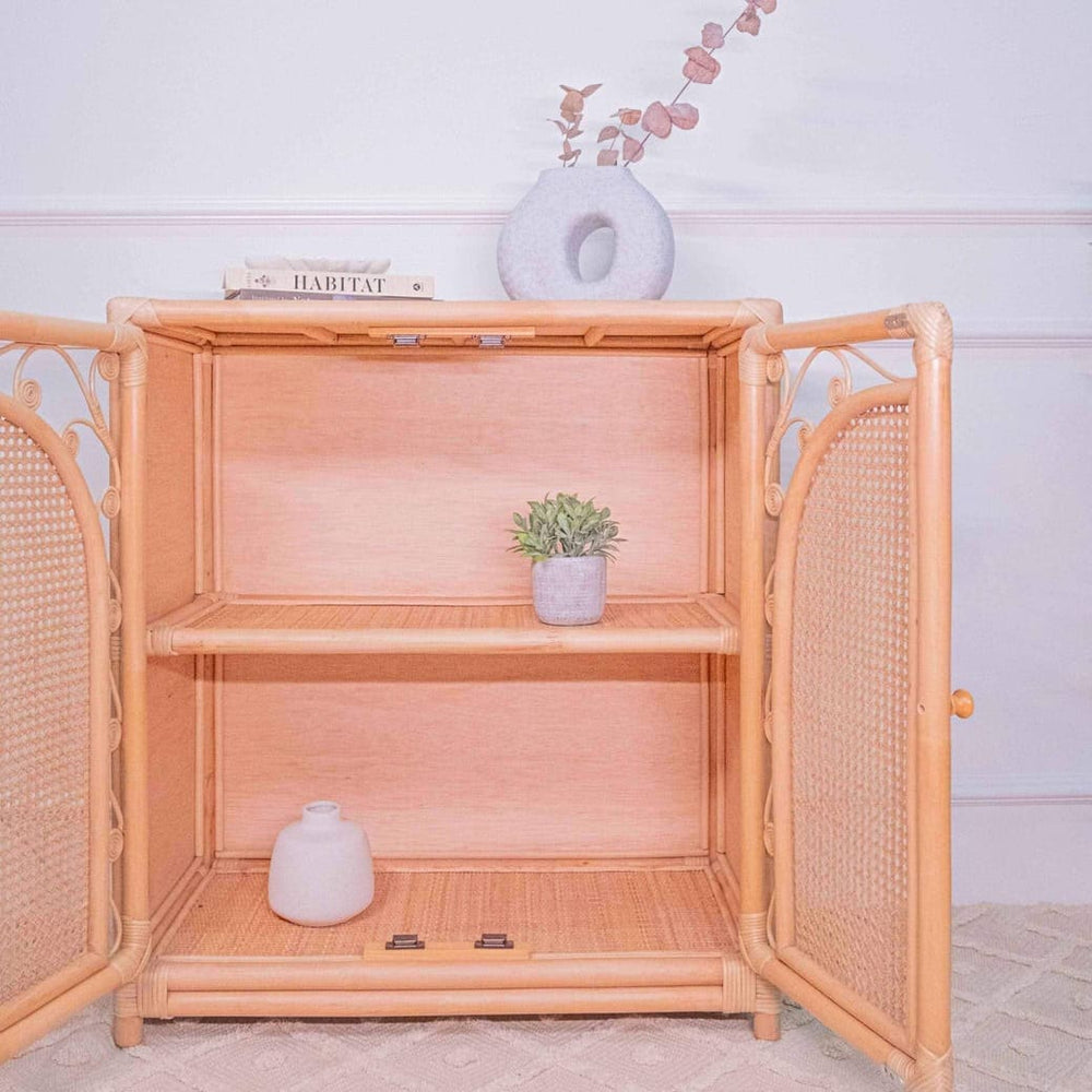 Handcrafted rattan Fern Storage Cabinet by MOMIJI opened to reveal interior shelving with decorative items.