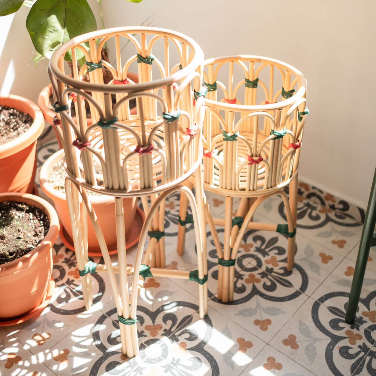 Two Iris Planters by MOMIJI placed outdoors with potted plants in front of a garden backdrop.