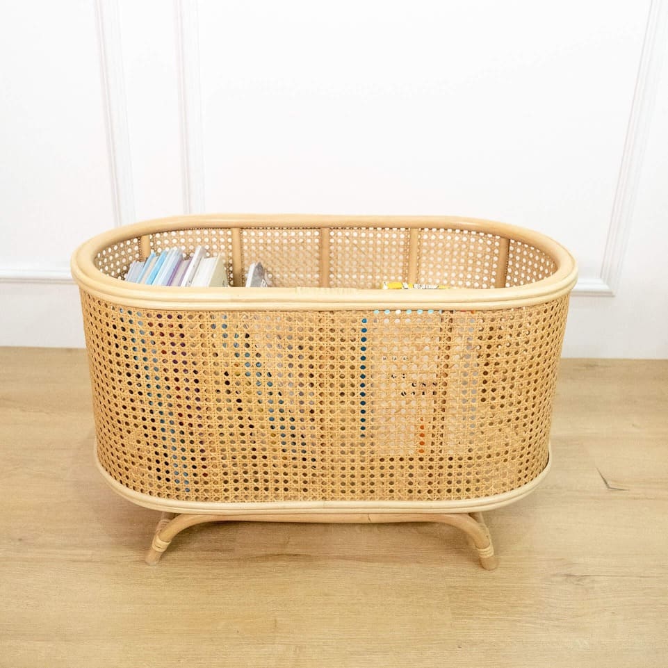 Top view of the Isle Wicker Plant Stand by MOMIJI with books placed on top.