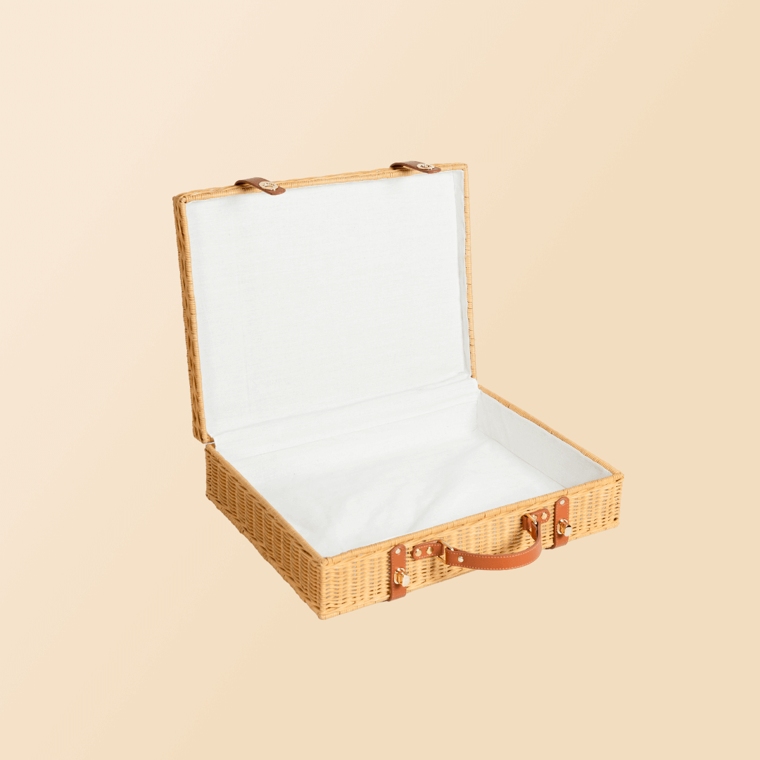 Open interior view of the Jasmine rattan Suitcase by MOMIJI showing its storage compartment.