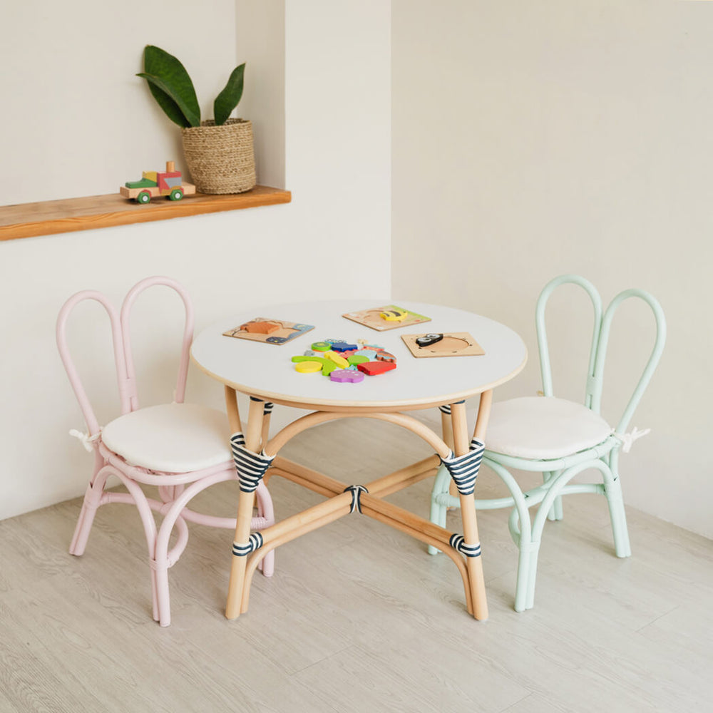 Pink & Mint-Green handcrafted Bunny Chairs by MOMIJI styled with a rattan table and toys in a playful kids room.
