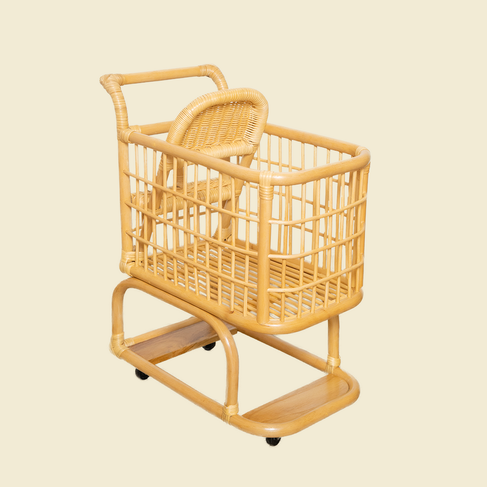 Front view of the handcrafted wicker rattan Kids Shopping Cart by MOMIJI, highlighting its spacious basket, smooth rolling wheels, and child friendly design