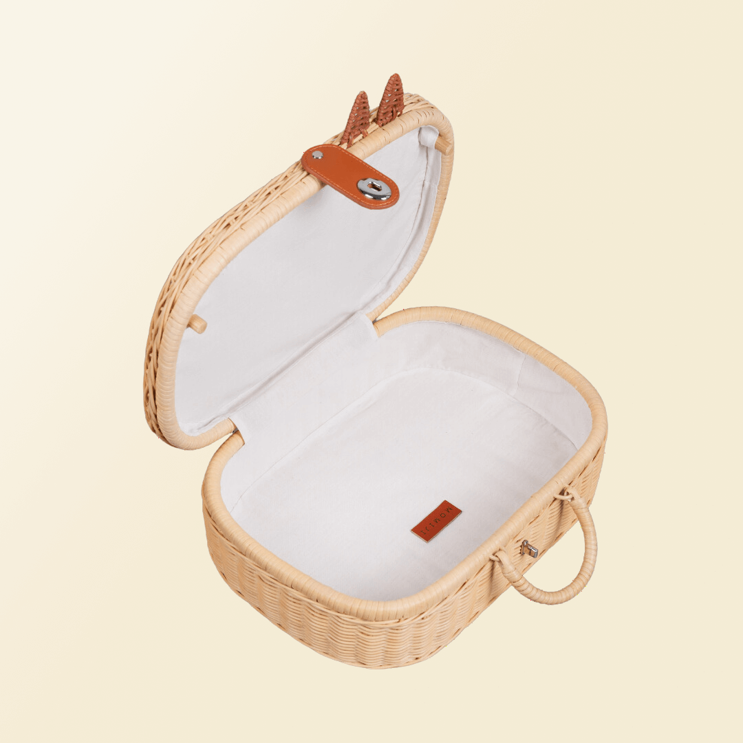 Open interior view of the handcrafted rattan Kitty Kids Suitcase by MOMIJI, showing its storage space.