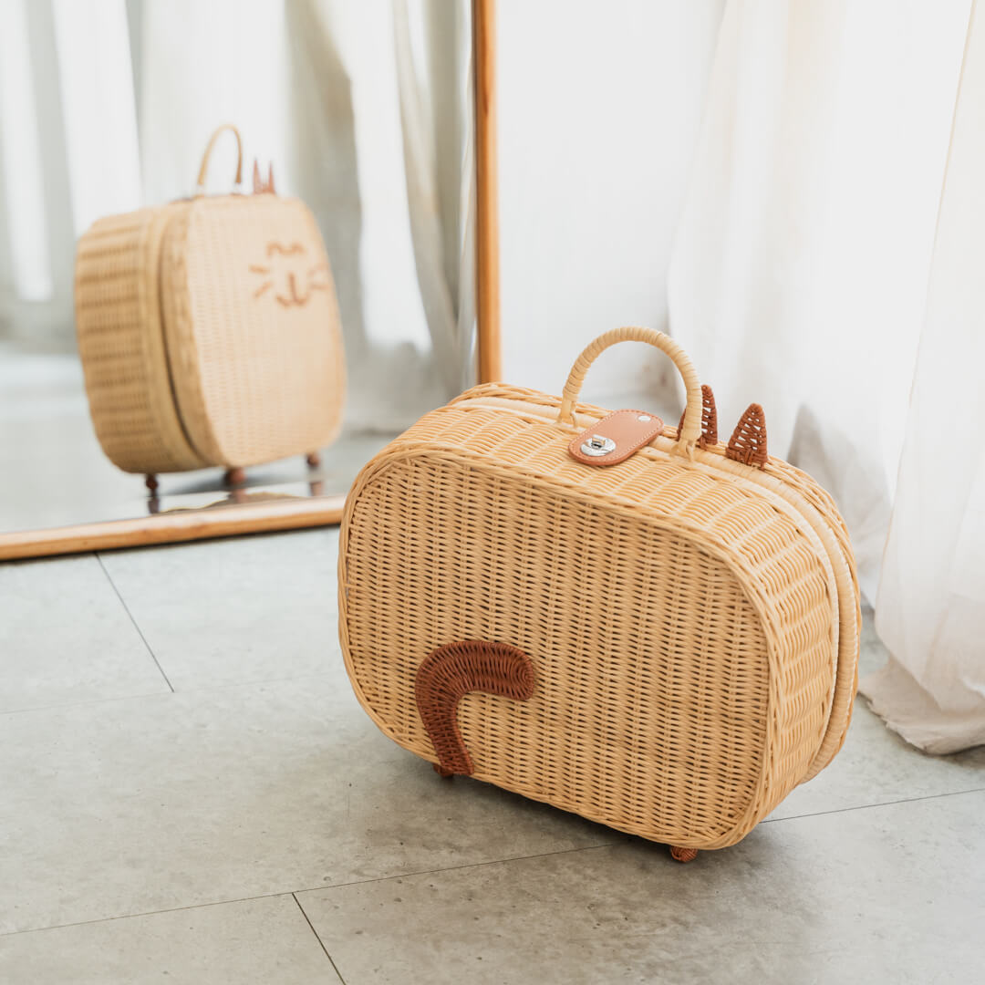 Back view of the handcrafed rattan basket Kitty Kids Suitcase by MOMIJI showing the tail design, styled in a room with a mirror reflect front design.