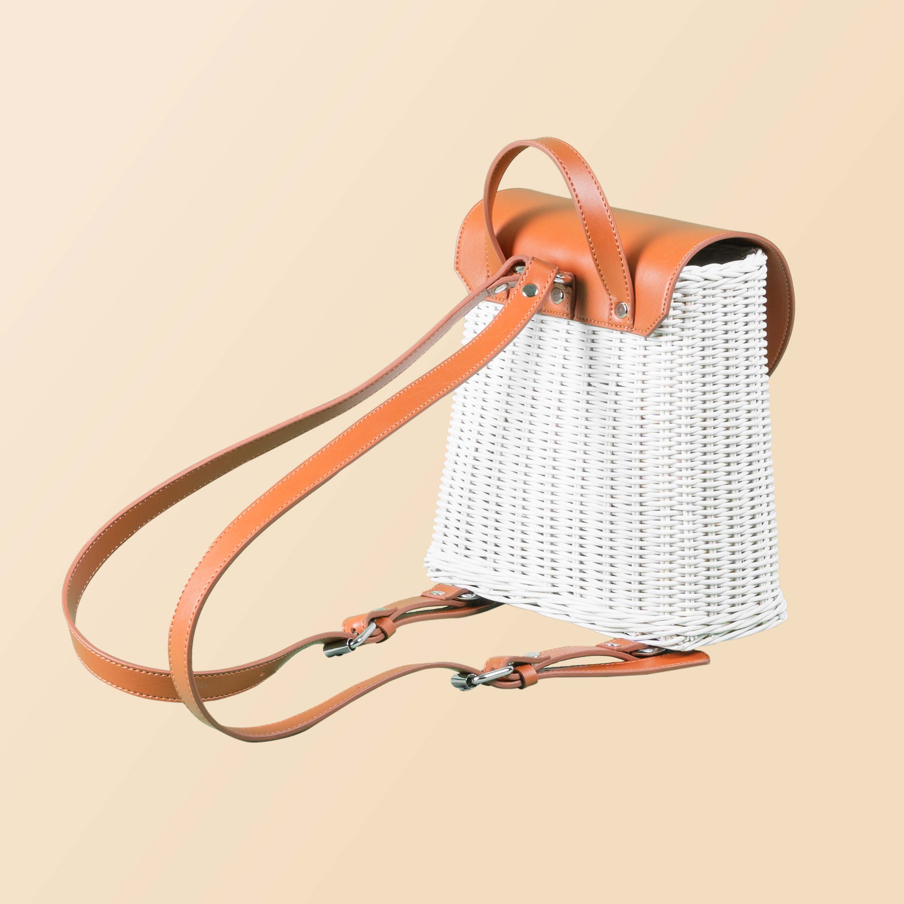 Back view of the handcrafted rattan Layla Backpack by MOMIJI, highlighting strap placement and supportive back panel.
