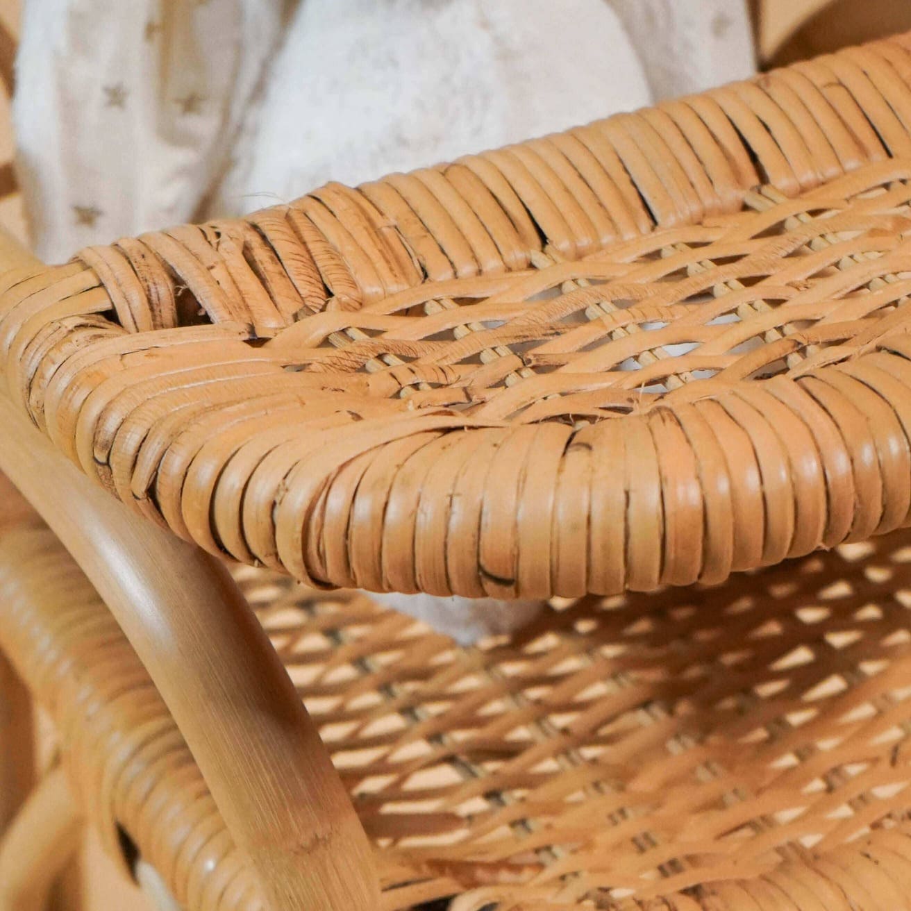 Close-up of the tray detail on the handcrafted rattan wicker Layla Doll High Chair by MOMIJI.