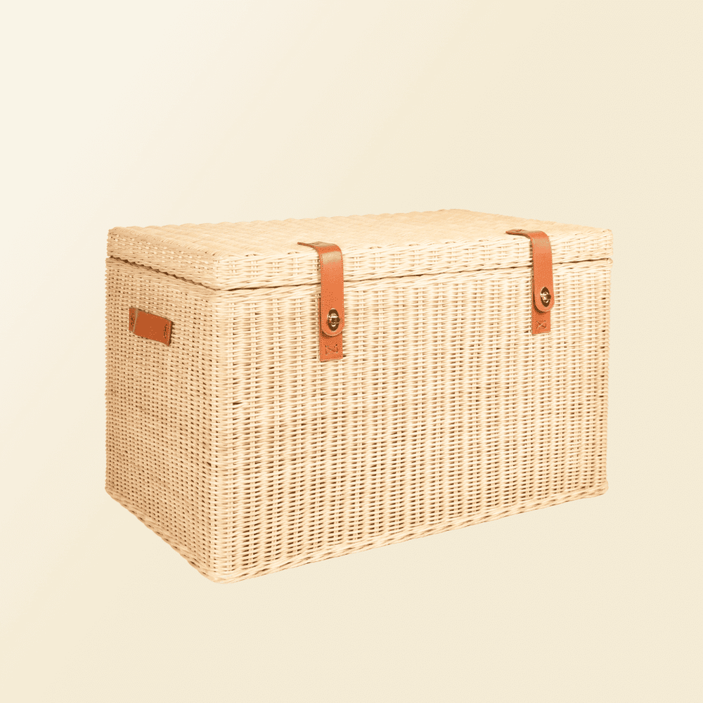 Angled view of the handcrafted rattan wicker Leon Leather Trunk by MOMIJI, highlighting the lock system and leather handle.