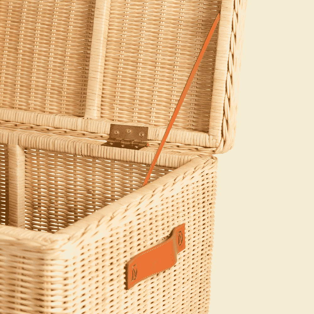 Close-up of the interior side support strap of the handcrafted rattan wicker Leon Leather Trunk by MOMIJI.