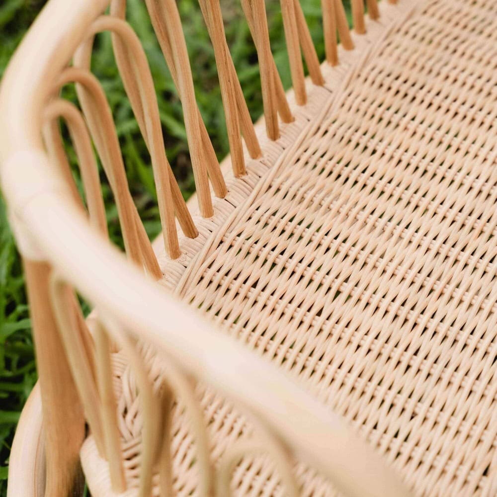 Close-up of the seat detail of the Leon Rocking Bench by MOMIJI, photographed in an outdoor setting.