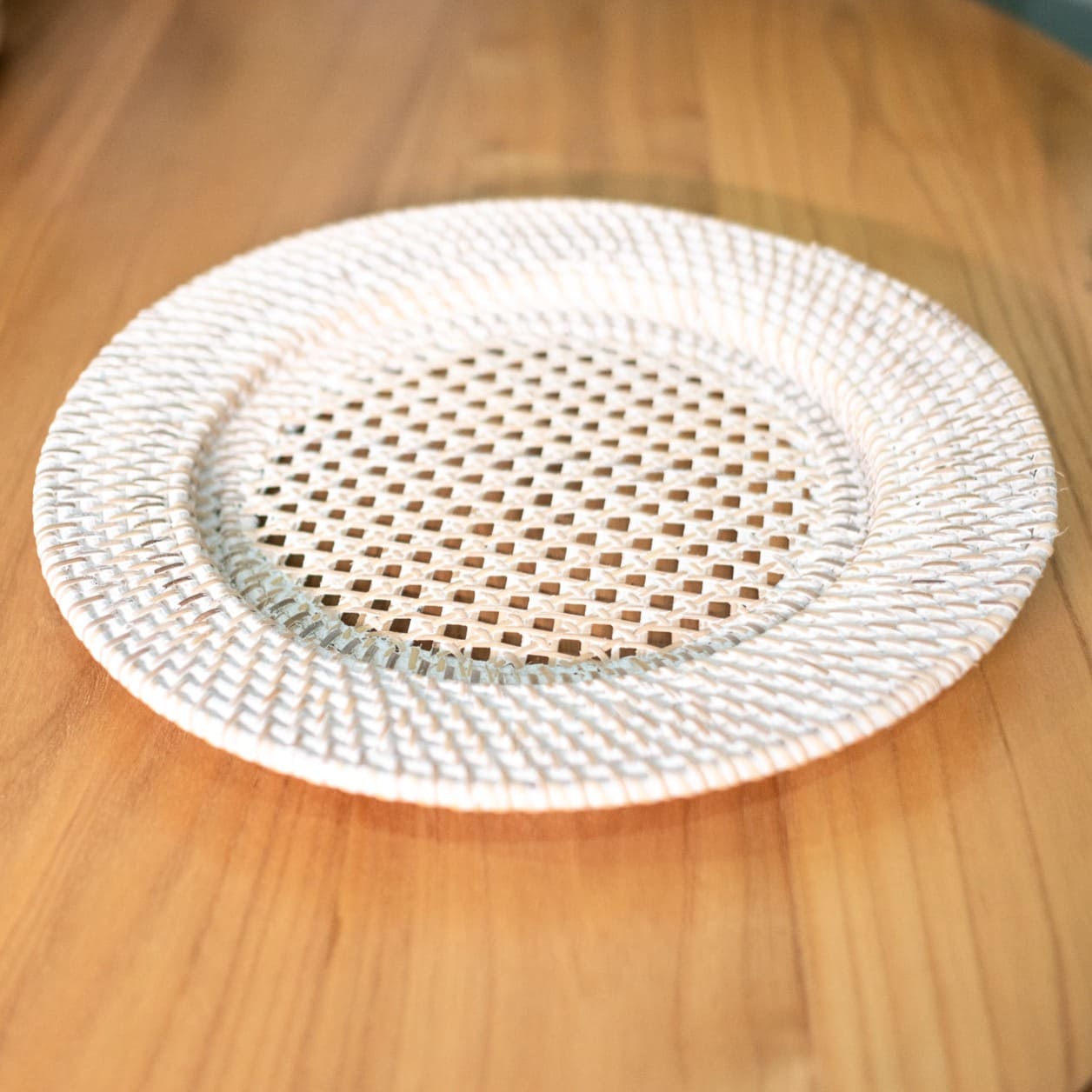 Top view of the Lily placemat by MOMIJI placed on a table, highlighting its floral pattern detail.