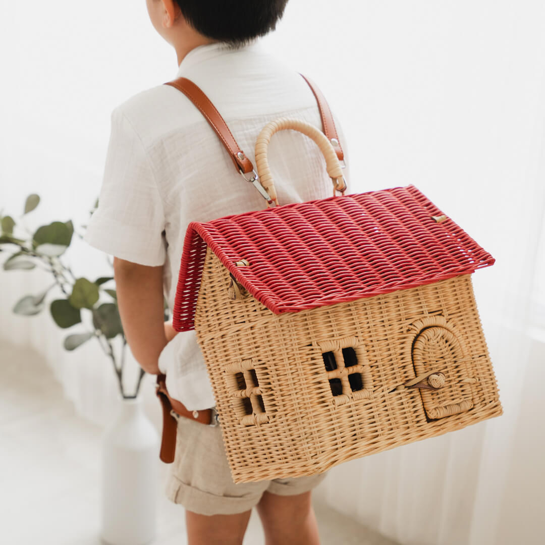 Child carrying the Lydia House Bag by MOMIJI in a cozy room setting.