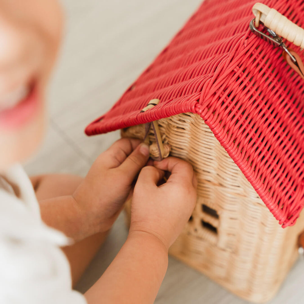 Close-up of a child’s hand holding the top opening of the Lydia House Bag by MOMIJI.