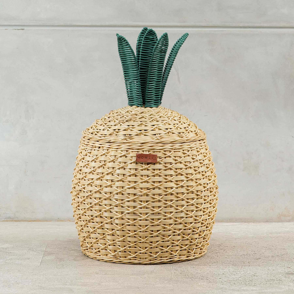Front view shot of Pineapple Rattan Storage Basket by MOMIJI on a light wooden floor.