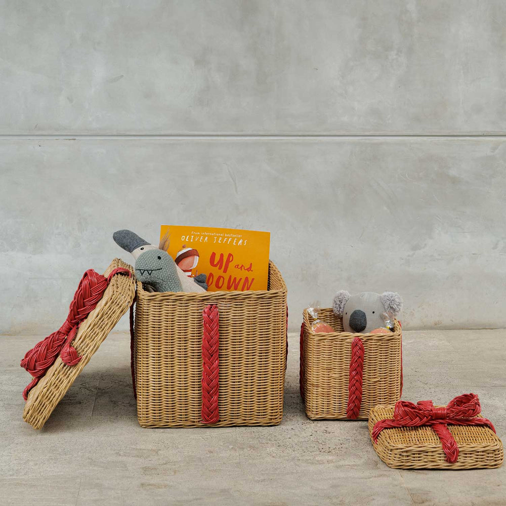 Large and Small Sized Rattan Basket Gift Boxes with Books, Toys, and Snacks Inside.