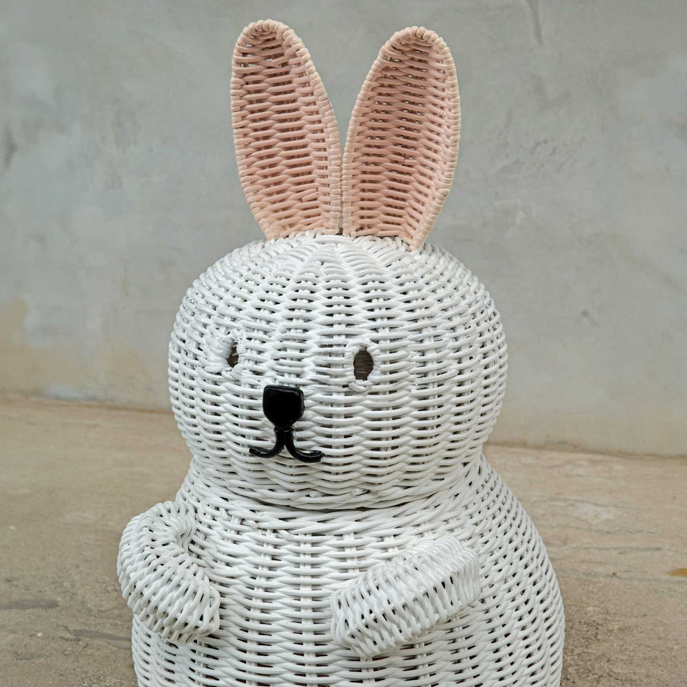 Close up Bunny Rattan Storage Basket by MOMIJI on a concrete background.