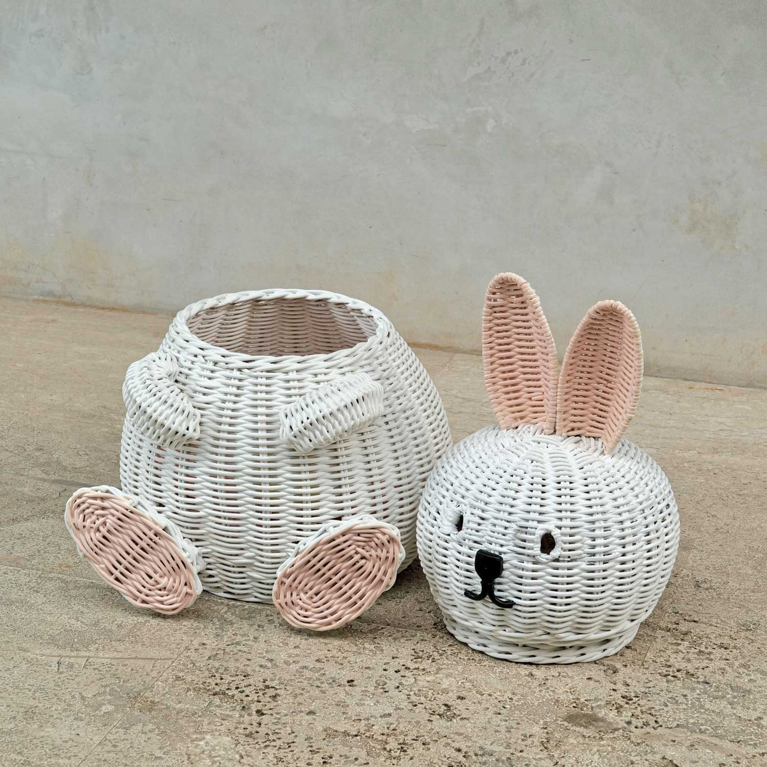 Bunny Rattan Storage Basket by MOMIJI, bunny head lid on the floor.