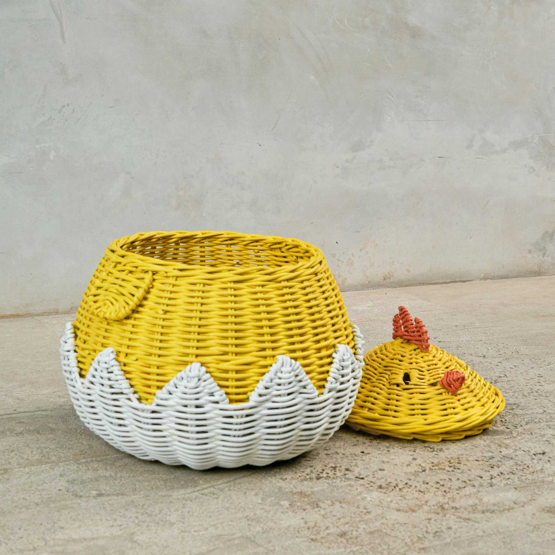 Chick Rattan Storage Basket by MOMIJI on a light concrete surface.
