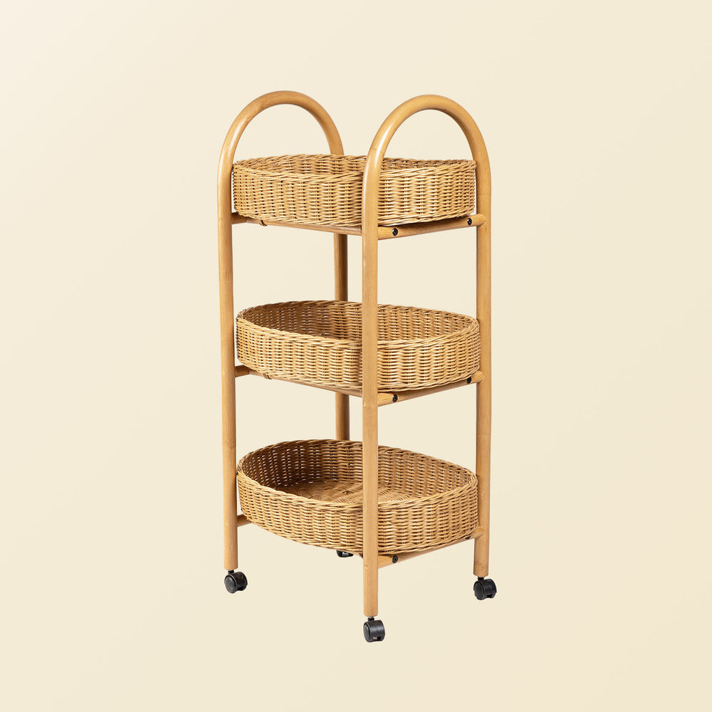 Handcrafted wicker rattan three-tiered utility cart with wheels on a beige background