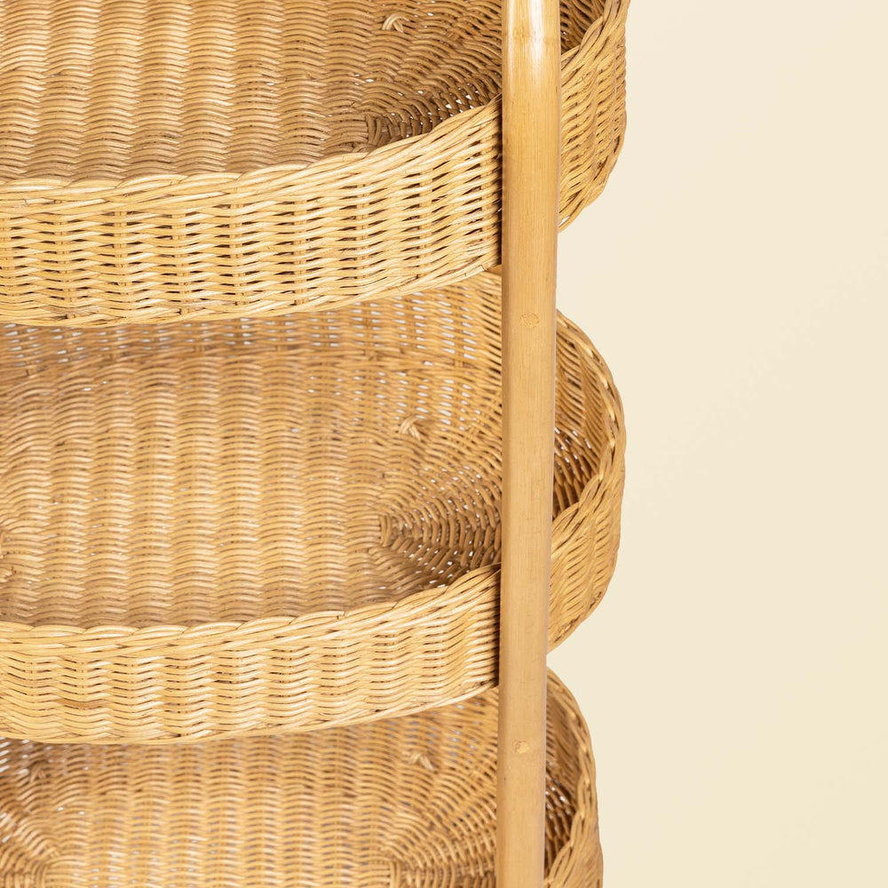 Close-up of handcrafted rattan wicker frame structure and three tier woven basket trays on a beige background