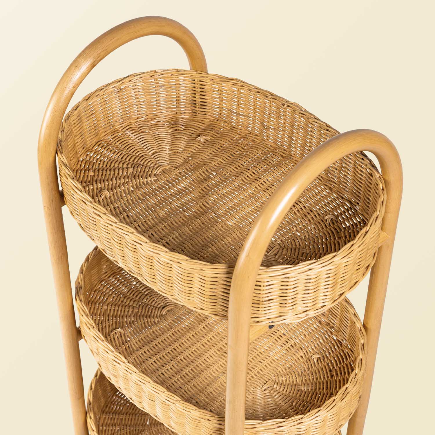 Handcrafted wicker rattan basket with integrated handles on a beige background for easy manoeuvring