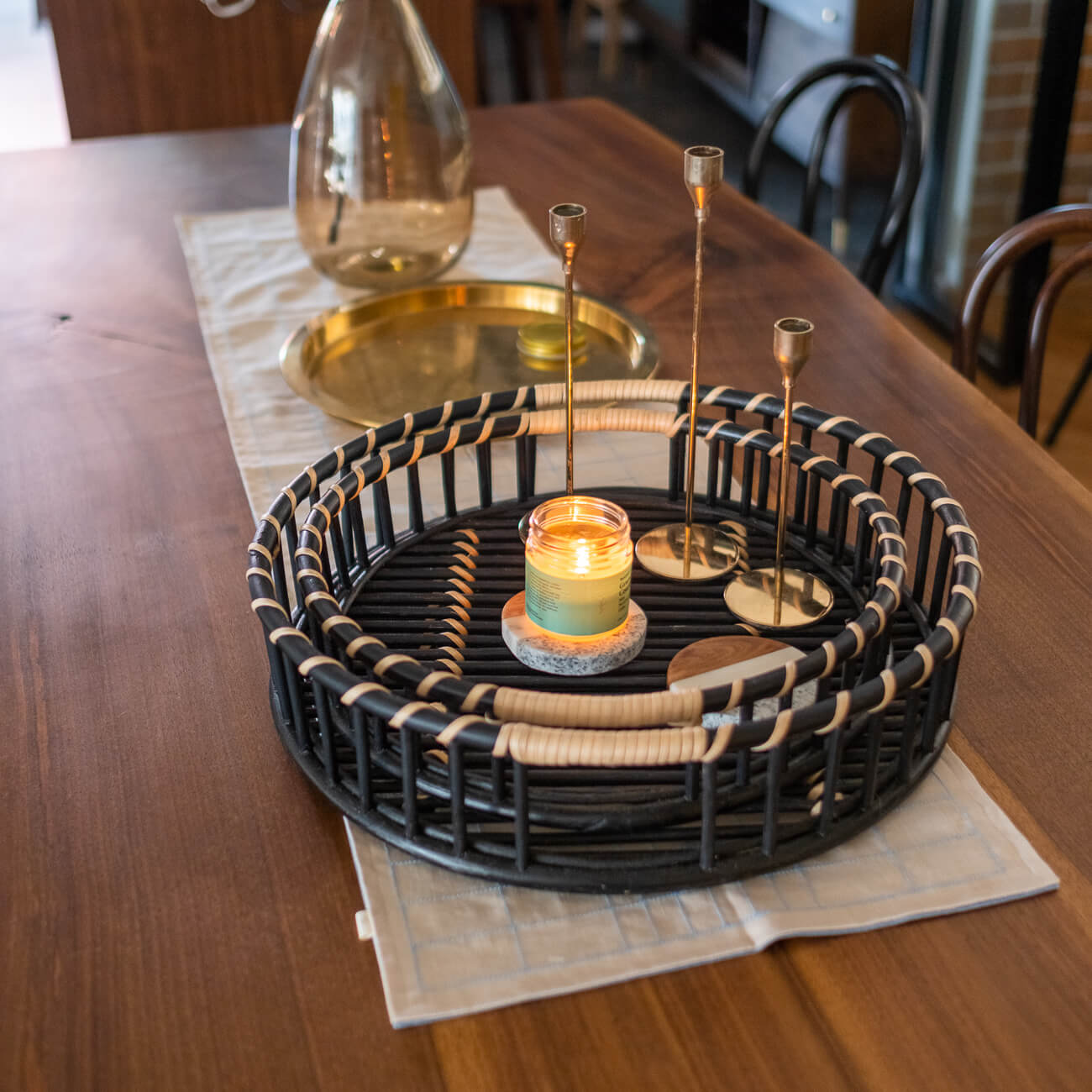 Maru Tray Set by MOMIJI styled with candles on a dining table in an indoor setting.