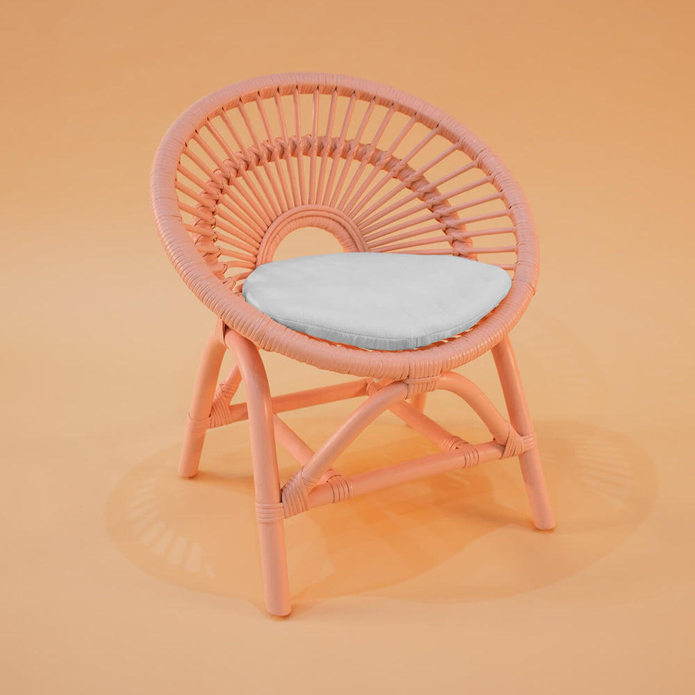 Angled view of the Maya Kids Chair by MOMIJI in peach pink.
