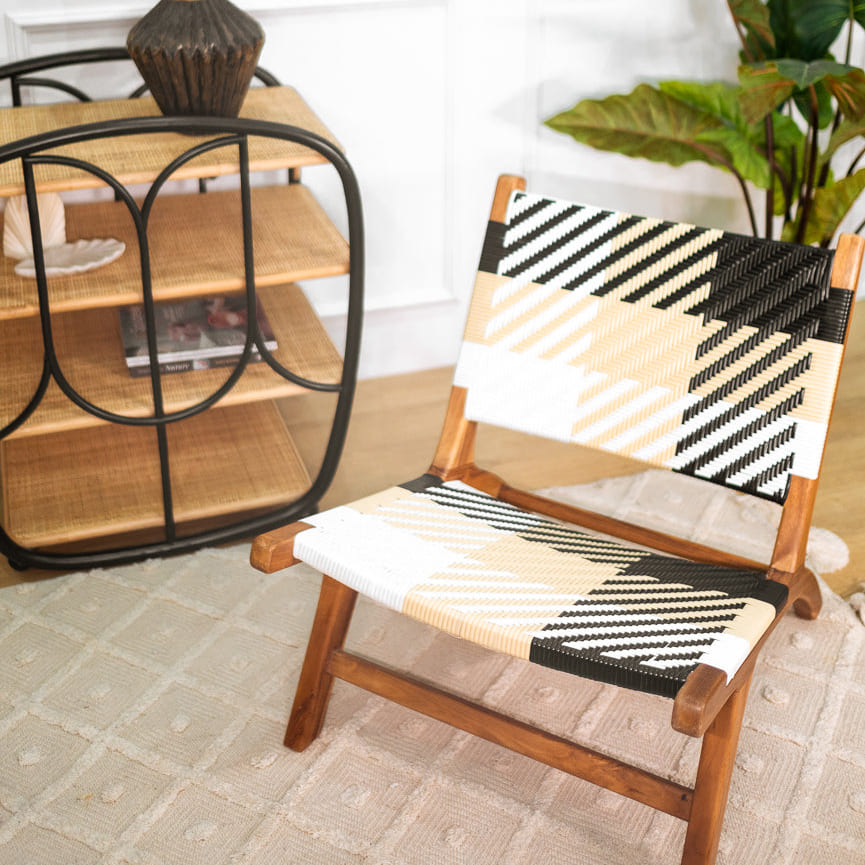 Mila Plaid Lounge Chair by MOMIJI styled indoors with a bar cart in the background.