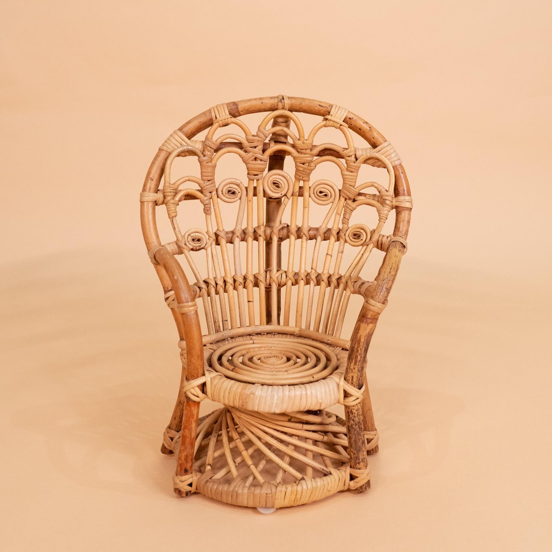 Front view of the handcrafted rattan wicker Mini Peacock Doll Chair by MOMIJI highlighting the carved rattan detail.