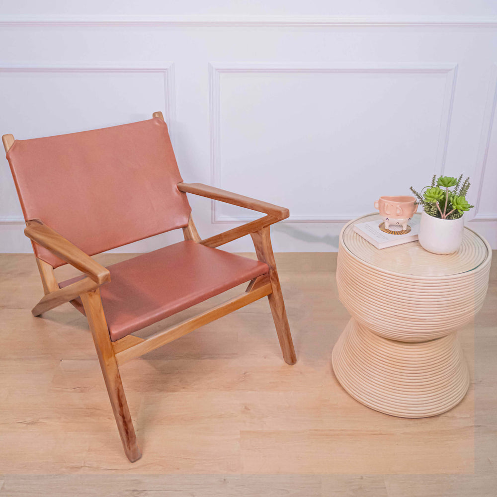 Angled view of the brown Monty Leather Lounge Chair by MOMIJI with wooden frame and armrests.