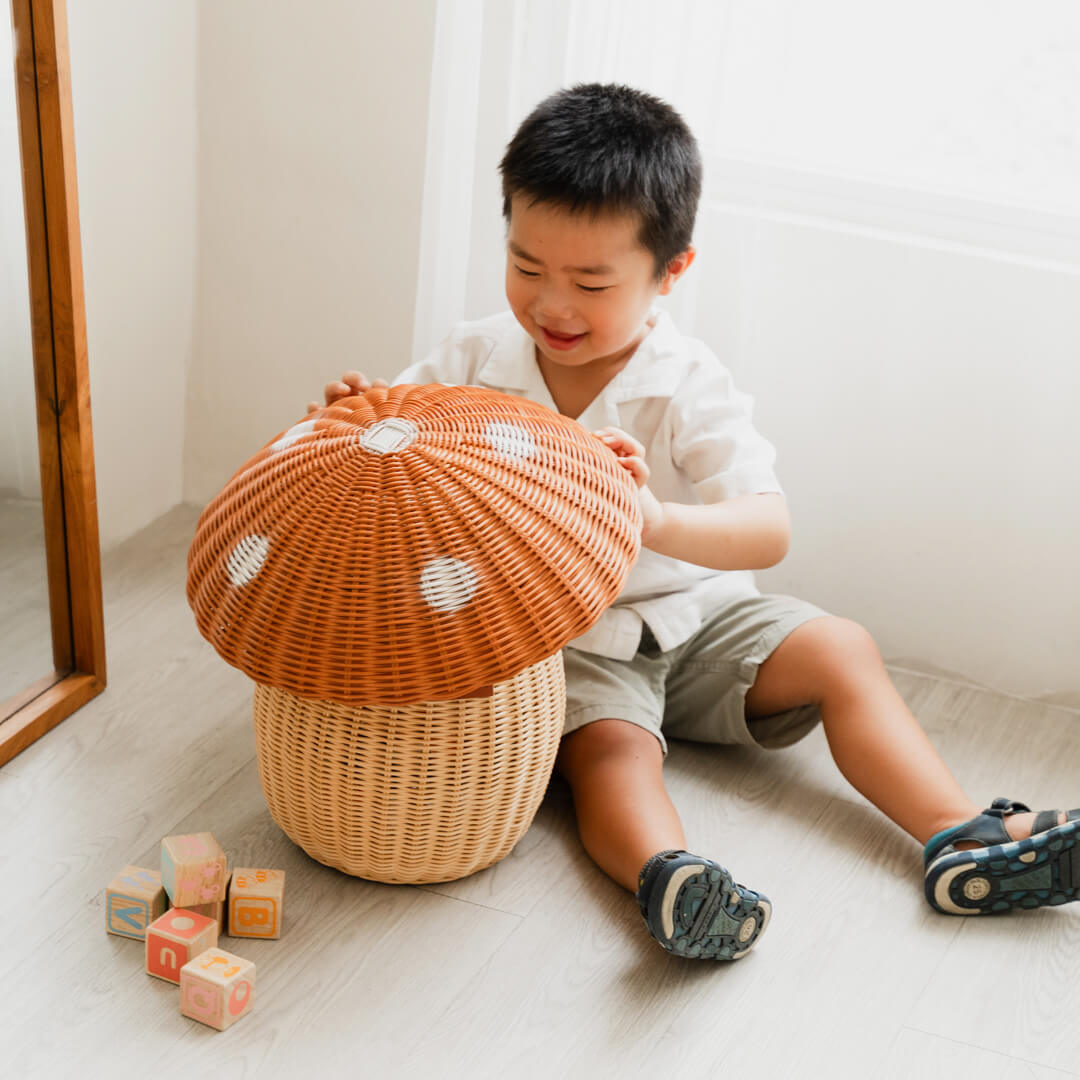 Child playing with the Mushroom Storage Rattan Basket by MOMIJI.
