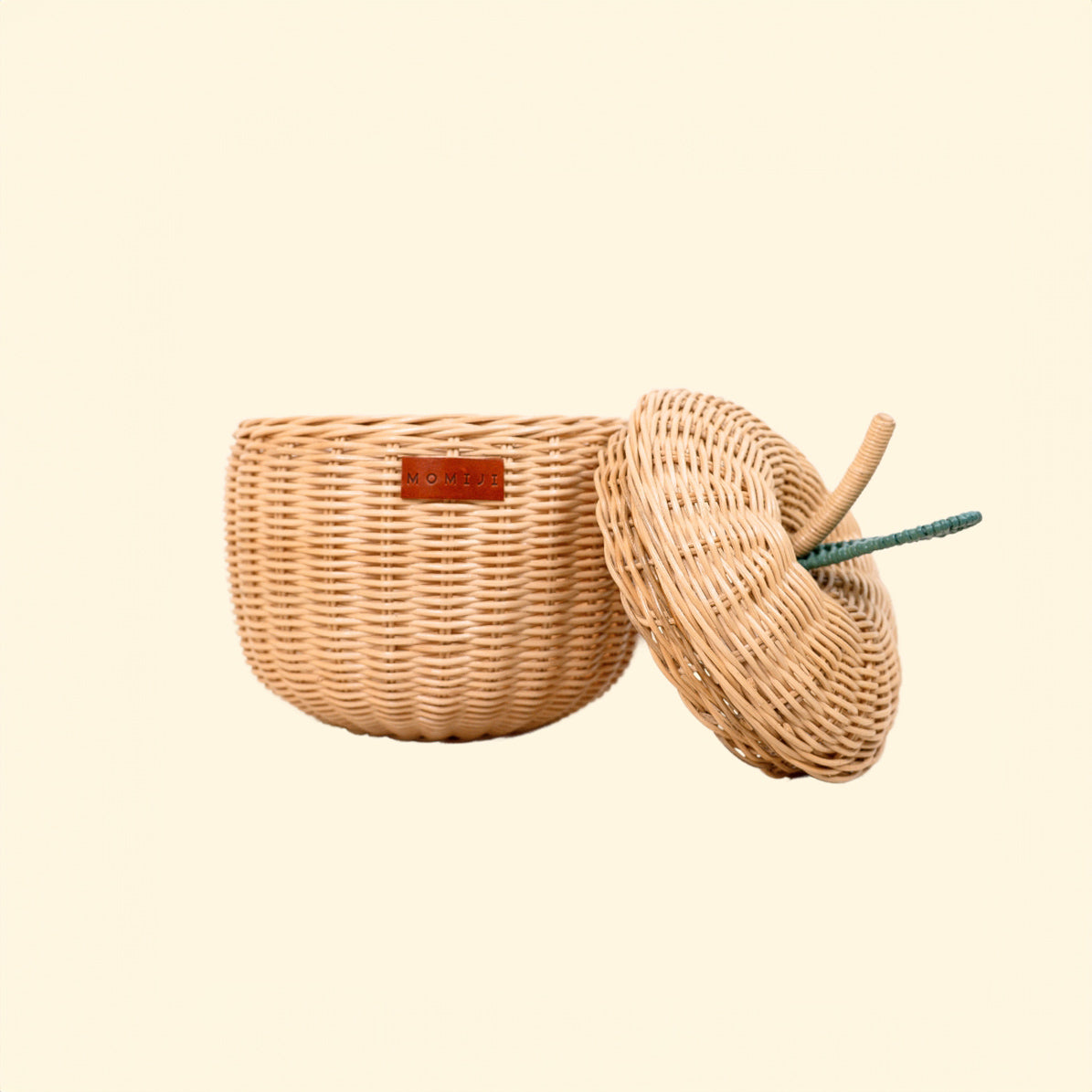 Front view of the Apple Rattan Storage Basket by MOMIJI in natural, small size, with the lid open.