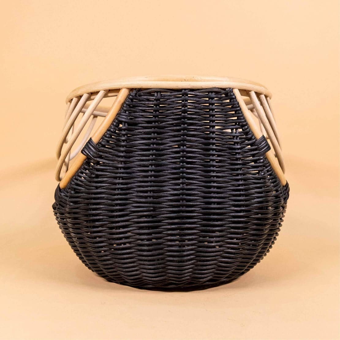 Back view of the handcrafted rattan wicker Nikko Basket by MOMIJI featuring black weaving with natural rattan accents, showing its woven structure.
