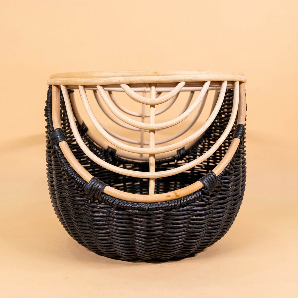 Front view of the handcrafted rattan wicker Nikko Basket by MOMIJI featuring black weaving with natural rattan accents, highlighting the carved handle detail.
