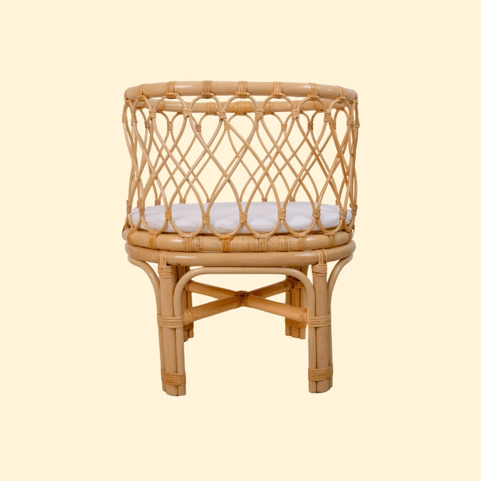 Front view of the Olivia Doll Bassinet by MOMIJI with white cushion, showcasing the fully handwoven rattan bassinet and stand.
