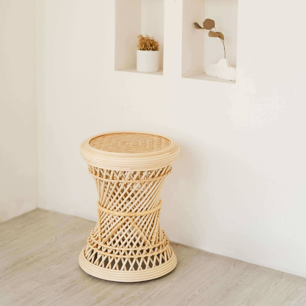 Palawan Stool by MOMIJI placed in a minimalistic room with white walls and a wooden floor.