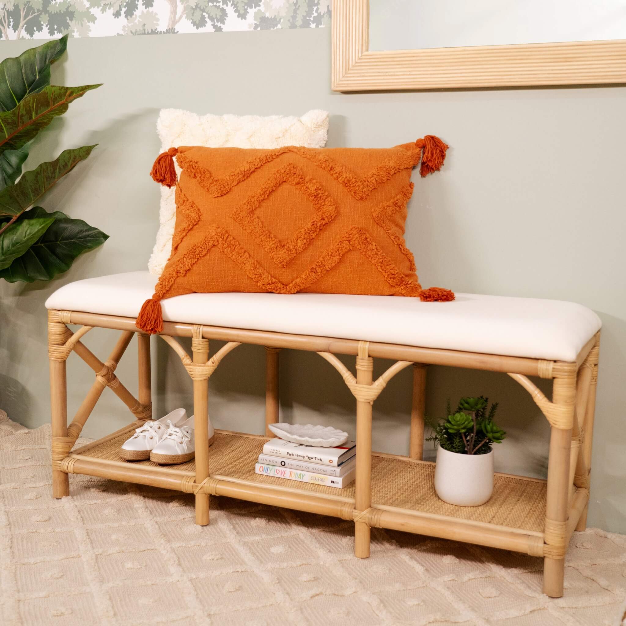 Angled view of the Palma Bench by MOMIJI with shoes, books, and a vase stored underneath.