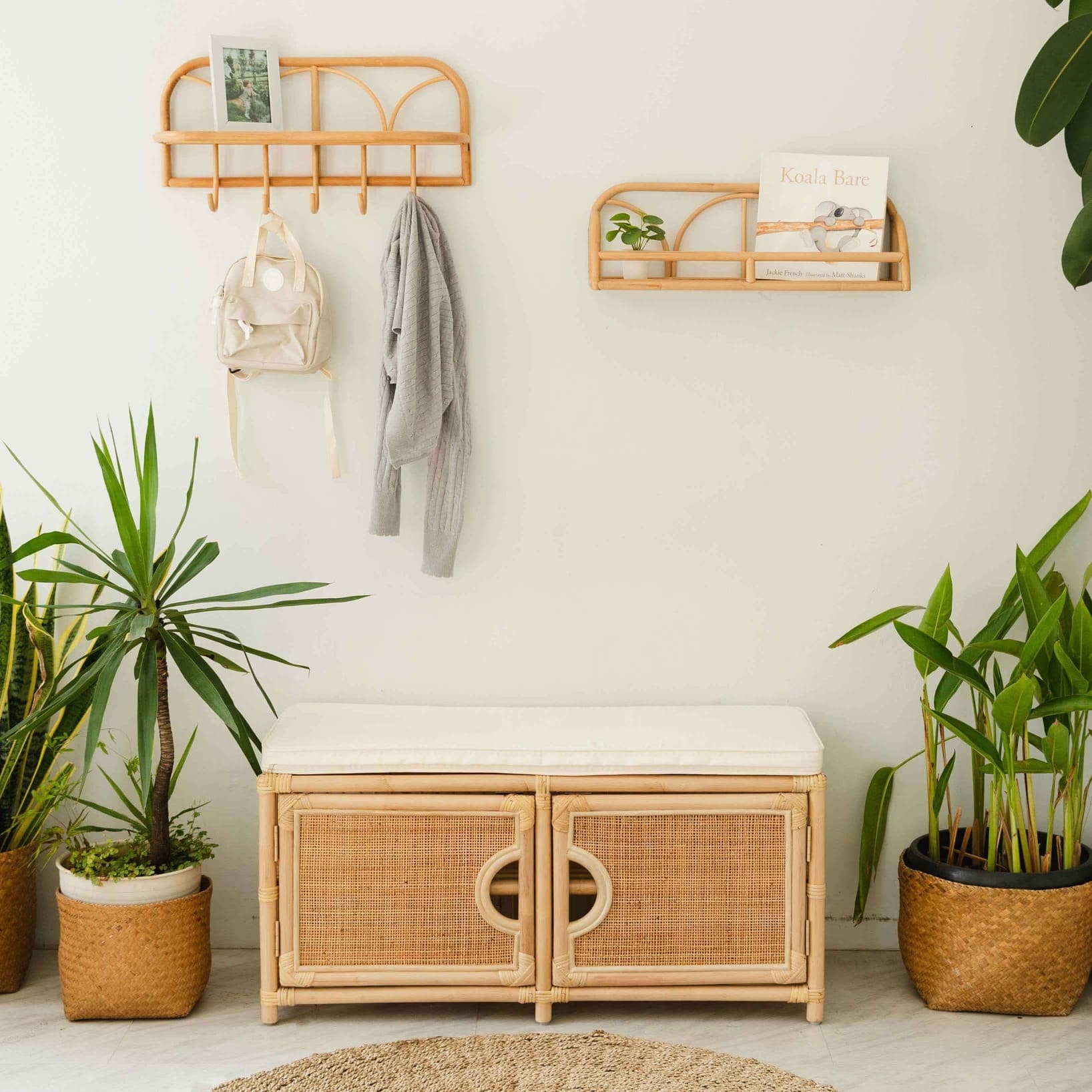 Palma Shoe Cabinet by MOMIJI styled as an entryway bench with a cushion, wall-mounted shelves, and indoor plants.